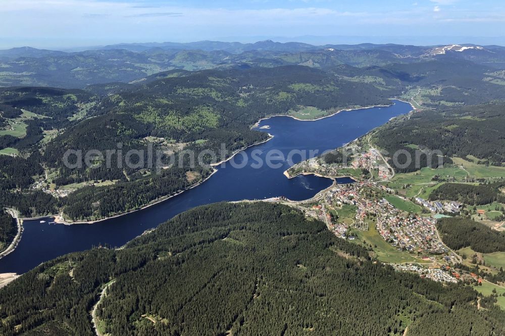 Schluchsee from above - Streaks of pollen float on the surface of Lake Schluchsee in Schluchsee in the state Baden-Wuerttemberg, Germany, Spring is comming and the last snow is melting on the two highest mountains in the Black Forest, the Herzogenhorn and Feldberg