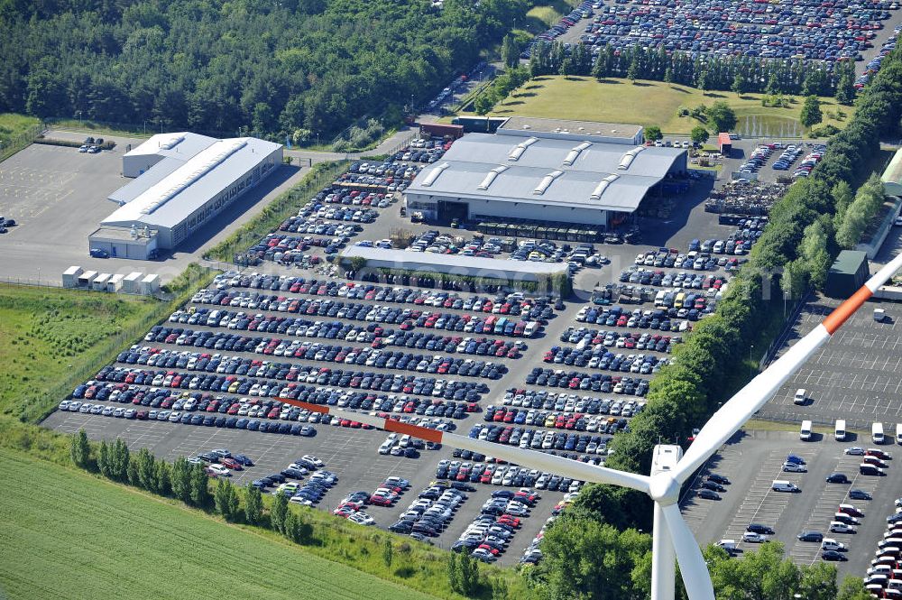 Aerial photograph Etzin - Gelände der Auto- Service-und Umschlag- Center Mosolf GmbH in Etzin bei Nauen. Die Firma besteht seit über 50 Jahren und bietet außer Logistikdienstleistungen, Kraftfahrzeugvermietung und -verkauf, ebenso Technik-, Prüfungs- und Ausstattungsdienste an. Site of the auto service center and transshipment Mosolf GmbH Etzin at Nauen. The company was founded over 50 years and in addition to logistics services, vehicle rental and sale, as well engineering, testing and equipment services.