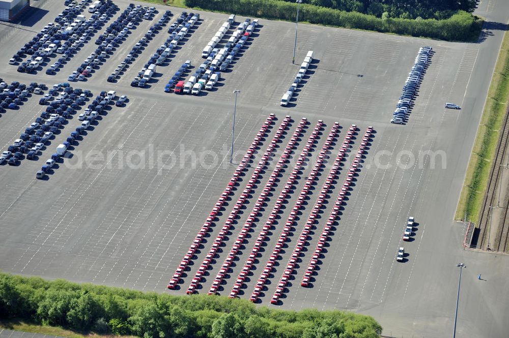 Aerial photograph Etzin - Gelände der Auto- Service-und Umschlag- Center Mosolf GmbH in Etzin bei Nauen. Die Firma besteht seit über 50 Jahren und bietet außer Logistikdienstleistungen, Kraftfahrzeugvermietung und -verkauf, ebenso Technik-, Prüfungs- und Ausstattungsdienste an. Site of the auto service center and transshipment Mosolf GmbH Etzin at Nauen. The company was founded over 50 years and in addition to logistics services, vehicle rental and sale, as well engineering, testing and equipment services.