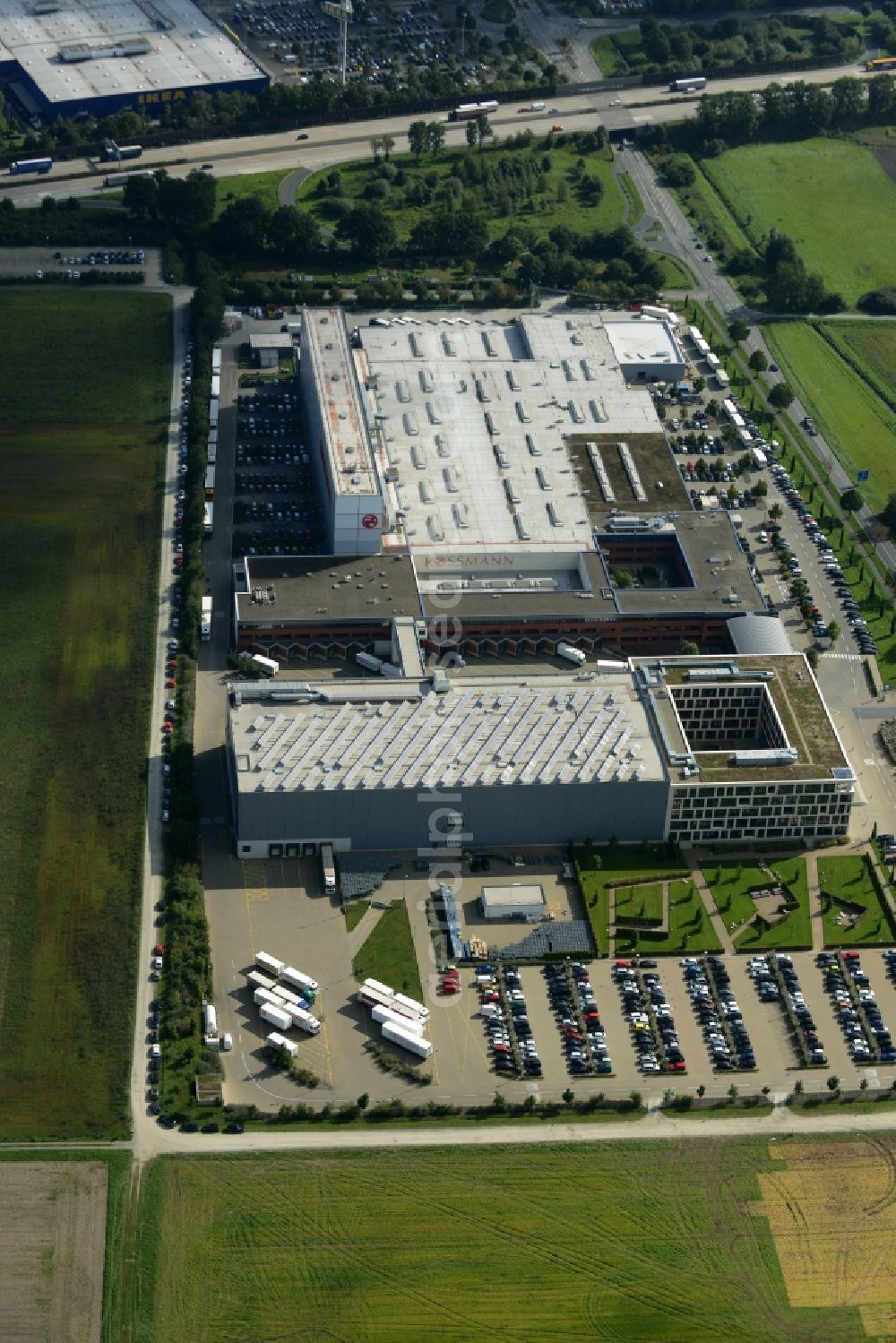 Burgwedel from the bird's eye view: Building complex and grounds of the Dirk Rossmann GmbH in Burgwedel in the state of Lower Saxony. The compound includes a logistics centre and the company headquarters and administrative offices of Rossmann