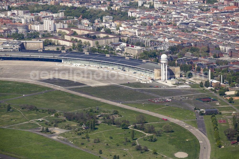 Berlin from the bird's eye view: Premises of the former airport Berlin-Tempelhof Tempelhofer Freiheit in the Tempelhof part of Berlin, Germany. The premises include the historic main building and radar tower as well as two runways. Its hangars are partly used as refugee and asylum seekers accommodations