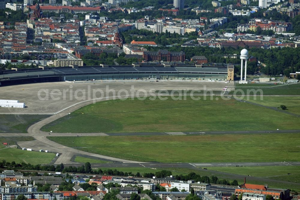 Aerial image Berlin - Premises of the former airport Berlin-Tempelhof Tempelhofer Freiheit in the Tempelhof part of Berlin, Germany. The premises include the historic main building and radar tower as well as two runways. Its hangars are partly used as refugee and asylum seekers accommodations