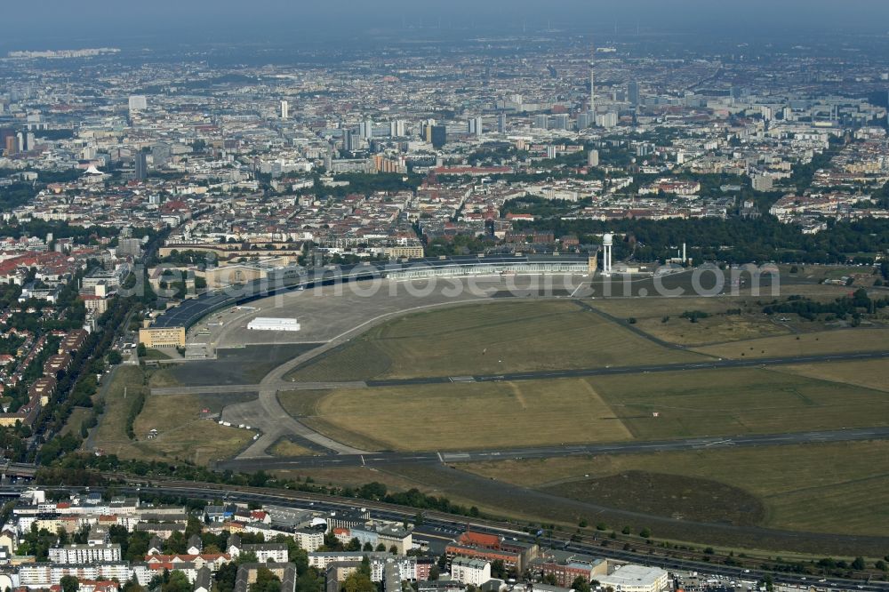 Aerial image Berlin - Premises of the former airport Berlin-Tempelhof Tempelhofer Freiheit in the Tempelhof part of Berlin, Germany. The premises include the historic main building and radar tower as well as two runways. Its hangars are partly used as refugee and asylum seekers accommodations