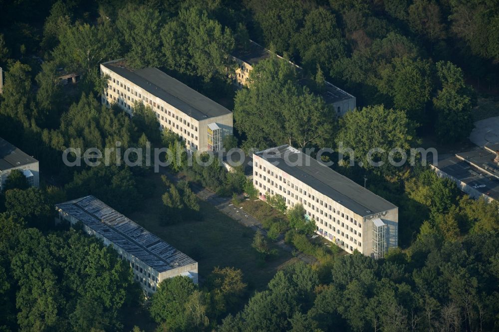 Berlin from the bird's eye view: Area of the former border training centre Wilhelmshage on Fuerstenwalder Strasse in Berlin in Germany. The empty, partly destroyed and decaying buildings of the military compound are surrounded by trees and forest