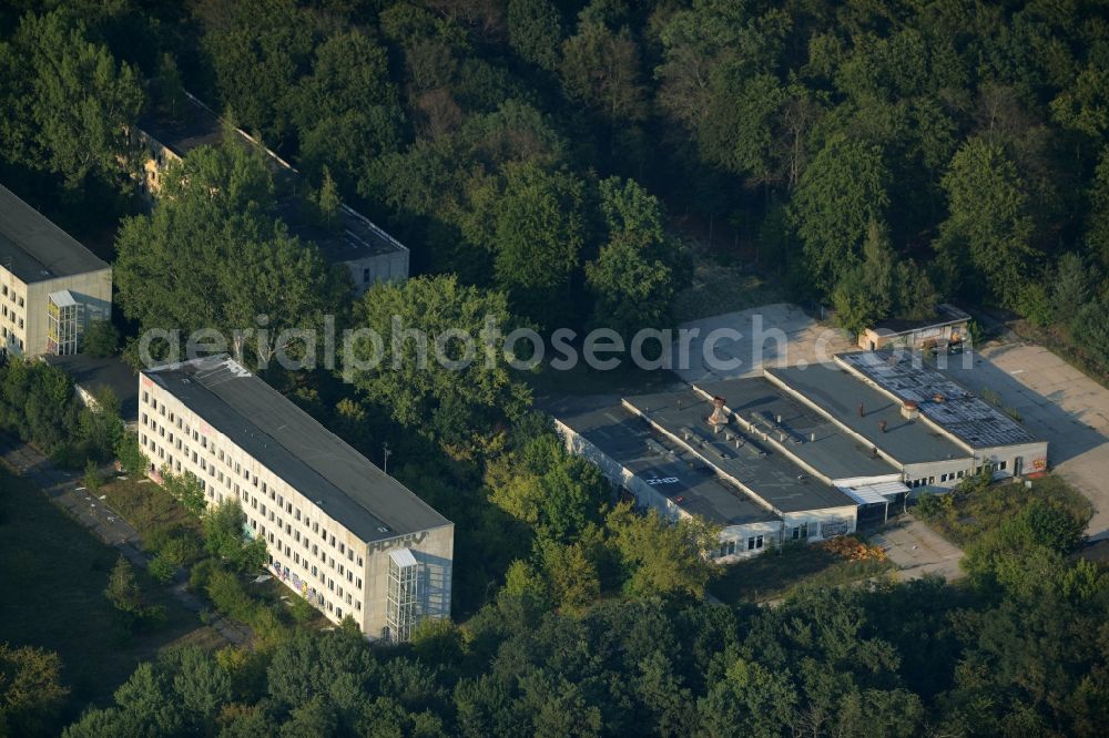 Aerial image Berlin - Area of the former border training centre Wilhelmshage on Fuerstenwalder Strasse in Berlin in Germany. The empty, partly destroyed and decaying buildings of the military compound are surrounded by trees and forest