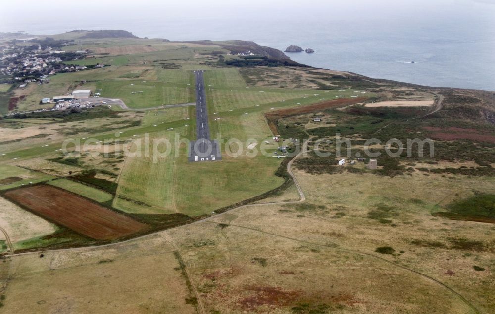 Aldernay from the bird's eye view: Runway with hangar taxiways and terminals on the grounds of the airport in Aldernay in Aurigny, Guernsey