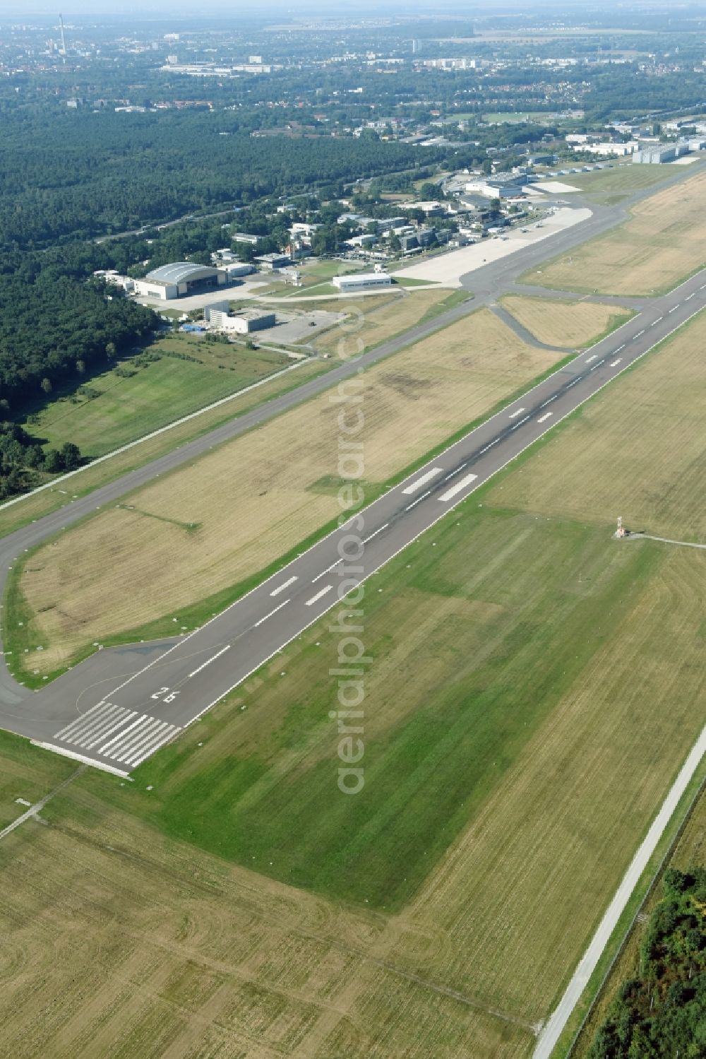 Braunschweig from the bird's eye view: Runway with hangar taxiways and terminals on the grounds of the airport Flughafen Braunschweig-Wolfsburg GmbH in Braunschweig in the state Lower Saxony