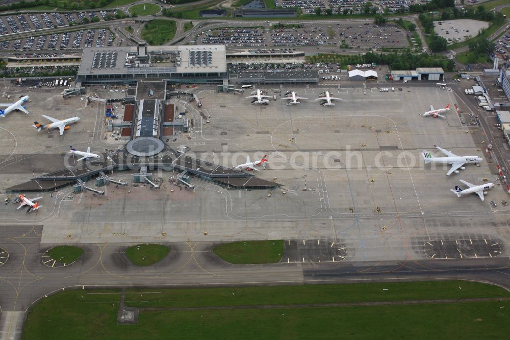 Saint-Louis from above - Hangars, Apron, tarmac, Taxiways, carpark and terminals on the grounds of the airport Euroairport in Saint-Louis in Alsace-Champagne-Ardenne-Lorraine, France