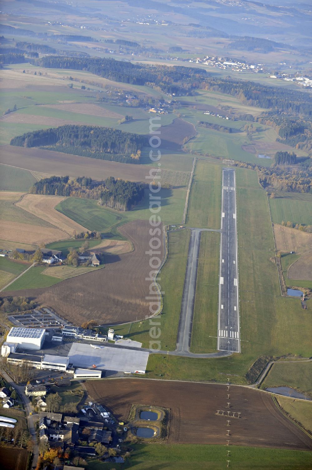 Hof from above - Runway with hangar taxiways and terminals on the grounds of the airport in Hof in the state Bavaria, Germany