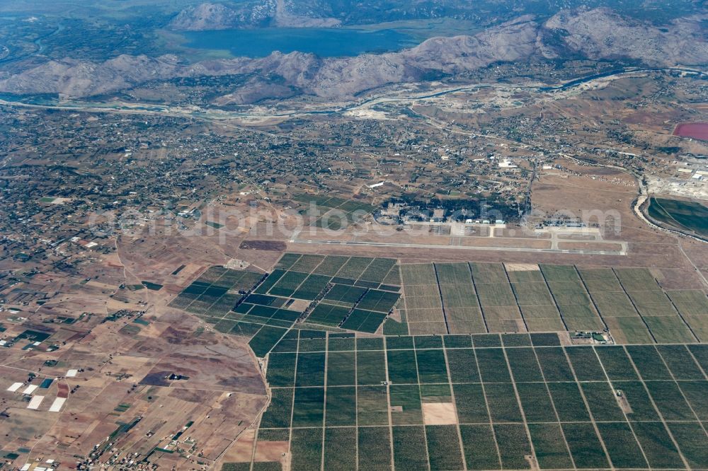 Podgorica from above - Runway with hangar taxiways and terminals on the grounds of the airport in Podgorica in Montenegro