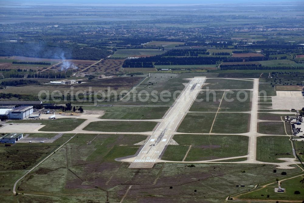 Aerial image Saint-Gilles - Runway with hangar taxiways and terminals on the grounds of the airport Nimes Airport in Saint-Gilles in Languedoc-Roussillon Midi-Pyrenees, France