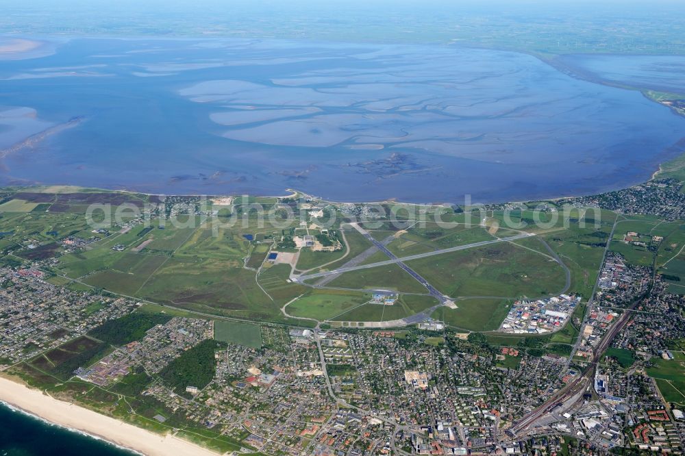 Aerial image Sylt - Runway with hangar taxiways and terminals on the grounds of the airport Sylt on Sylt with the town center of Westerland in the state Schleswig-Holstein