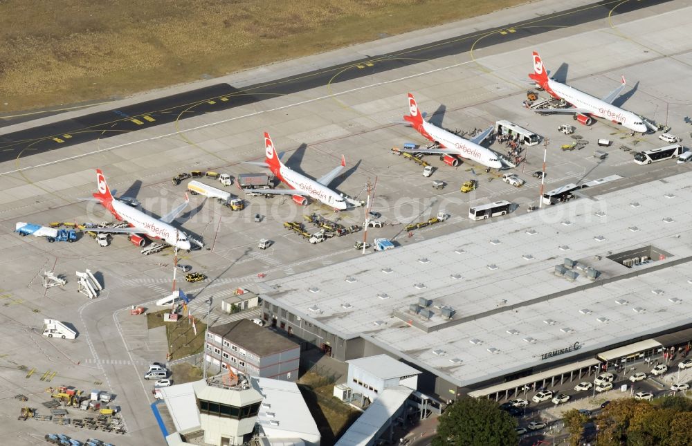 Berlin from above - Runway with hangar taxiways and terminals on the grounds of the airport Tegel with parked airberlin - aircraft on the apron at the gate in Berlin