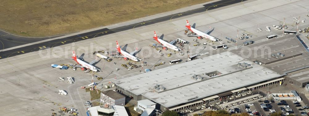 Berlin from the bird's eye view: Runway with hangar taxiways and terminals on the grounds of the airport Tegel with parked airberlin - aircraft on the apron at the gate in Berlin