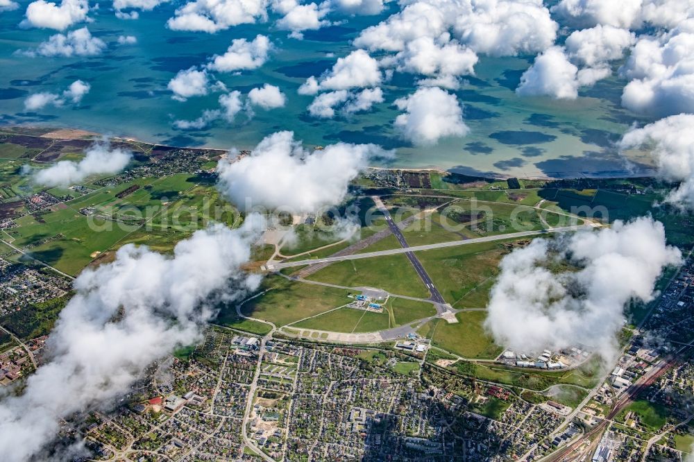 Aerial photograph Sylt - Runway with hangar taxiways and terminals on the grounds of the airport Westerland at the island Sylt in the state Schleswig-Holstein, Germany