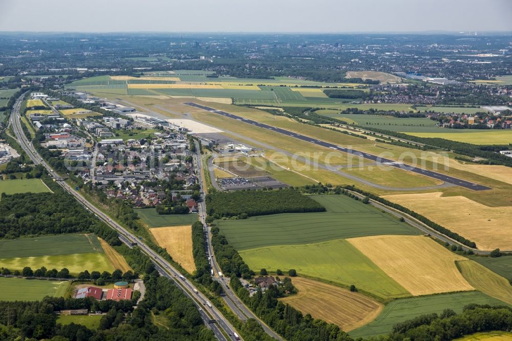 Aerial image Unna - View of the Airport Dortmund in the state of North Rhine-Westphalia. View of the runway with hangars, taxiways and terminals on the grounds of the airport Dortmund Airport 21. Federal highway B1 takes its course in the South of the airport compound