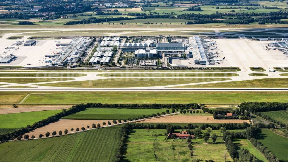 Aerial image Oberding - Runways with taxiways, hangars and terminals on the area of Munich Airport in the state of Bavaria. Munich Airport Franz Josef Strauss (IATA: MUC, ICAO: EDDM) is the commercial airport in the Bavarian capital of Munich and is one of the largest aviation hubs in Europe