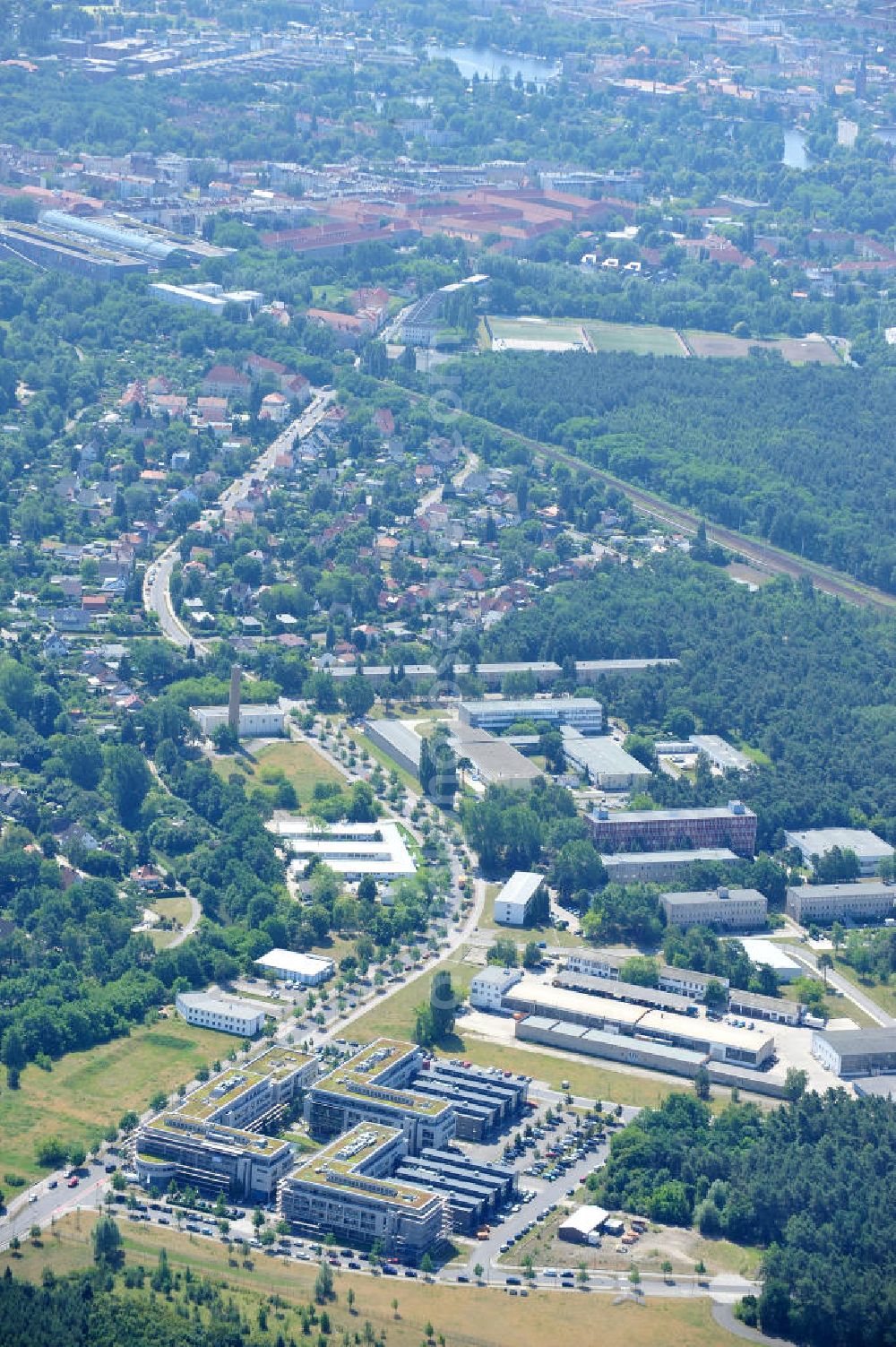 Berlin from above - Blick auf das Gelände des Innovationspark Wuhlheide auf dem ehemaligen Gelände des Ministeriums für Wissenschaft und Technik der DDR. Seit seiner Gründung im Jahr 1990 als erstes Technologie- und Gründerzentrum der neuen Bundesländer hat sich der IWP in Berlin zu einem wichtigen Gewerbe-Campus des Bezirks Treptow-Köpenick entwickelt.Betreiber ist die IMG mbH Innovationspark Wuhlheide Managementgesellschaft. The site of innovation Wuhlheide on the former site of the Ministry of Science and Technology of the GDR.