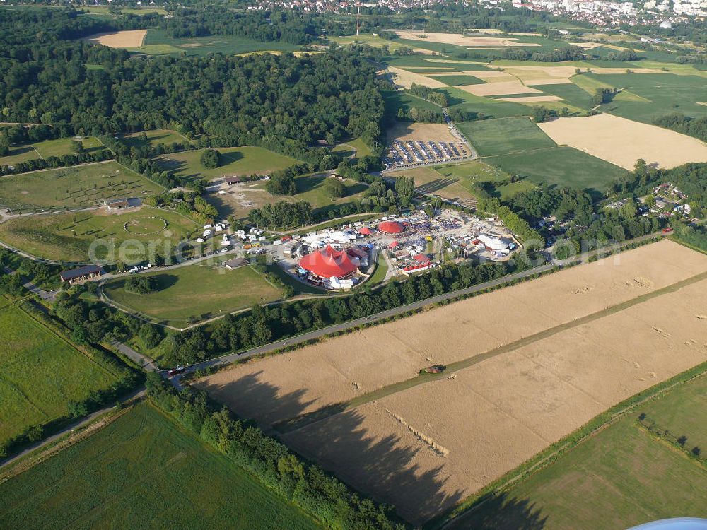 Aerial photograph Freiburg - Blick auf das Gelände des ZMF Zelt-Musik-Festival Freiburg zur Eröffnung im 25. Jahr seines Bestehens. Das Zelt-Musik-Festival ist eines der ältesten Zeltfestivals in Europa. Sein einmalige Mischung aus Zeltstadt, Natur und Kultur und ein hochkarätiges und vielfältiges Programm haben das Festival zu einem Begriff in der internationalen Festivallandschaft werden lassen. View of the site of the tent ZMF Freiburg Music Festival opening in the 25th Years of its existence. The tent-Music-Festival is one of the oldest tent festivals in Europe. His unique blend of tent city, nature and culture and a high caliber and diverse program have turned the festival into a household name in the international festival landscape.