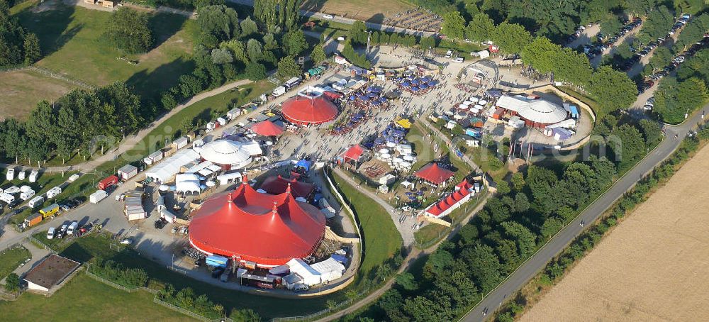 Aerial photograph Freiburg - Blick auf das Gelände des ZMF Zelt-Musik-Festival Freiburg zur Eröffnung im 25. Jahr seines Bestehens. Das Zelt-Musik-Festival ist eines der ältesten Zeltfestivals in Europa. Sein einmalige Mischung aus Zeltstadt, Natur und Kultur und ein hochkarätiges und vielfältiges Programm haben das Festival zu einem Begriff in der internationalen Festivallandschaft werden lassen. View of the site of the tent ZMF Freiburg Music Festival opening in the 25th Years of its existence. The tent-Music-Festival is one of the oldest tent festivals in Europe. His unique blend of tent city, nature and culture and a high caliber and diverse program have turned the festival into a household name in the international festival landscape.