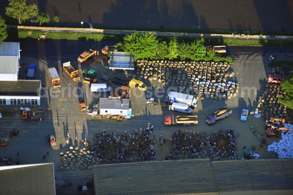 Magdeburg from above - Joint filling / filling sandbags on a commercial complex at the Werner-Heisenberg-road to prepare for flood protection on the banks of the Elbe in Magdeburg in Saxony-Anhalt