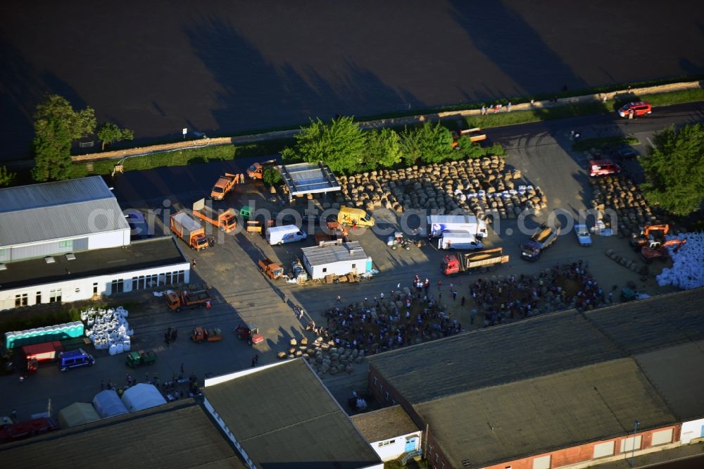 Magdeburg from above - Joint filling / filling sandbags on a commercial complex at the Werner-Heisenberg-road to prepare for flood protection on the banks of the Elbe in Magdeburg in Saxony-Anhalt