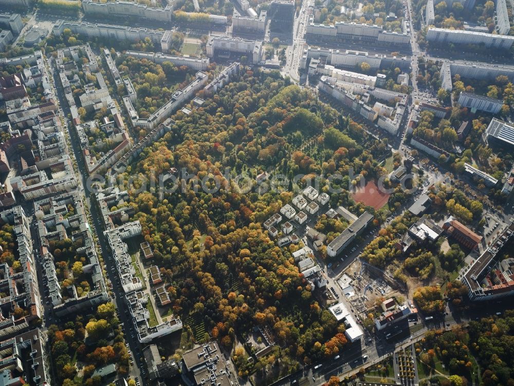 Aerial photograph Berlin - Georgen Parochial cemeteries II and V in the Friedrichshain part of Berlin. The historic cemeteries are two of five burial sites of the evangelical protestant Georgen-Parochial community and were built in 1867. They are located on Landsberger Allee and Friedenstrasse. Karl-Marx-Allee - an important road in the East of Berlin - is located in the background. Several residential buildings and estates are located on the parks of the cemeteries