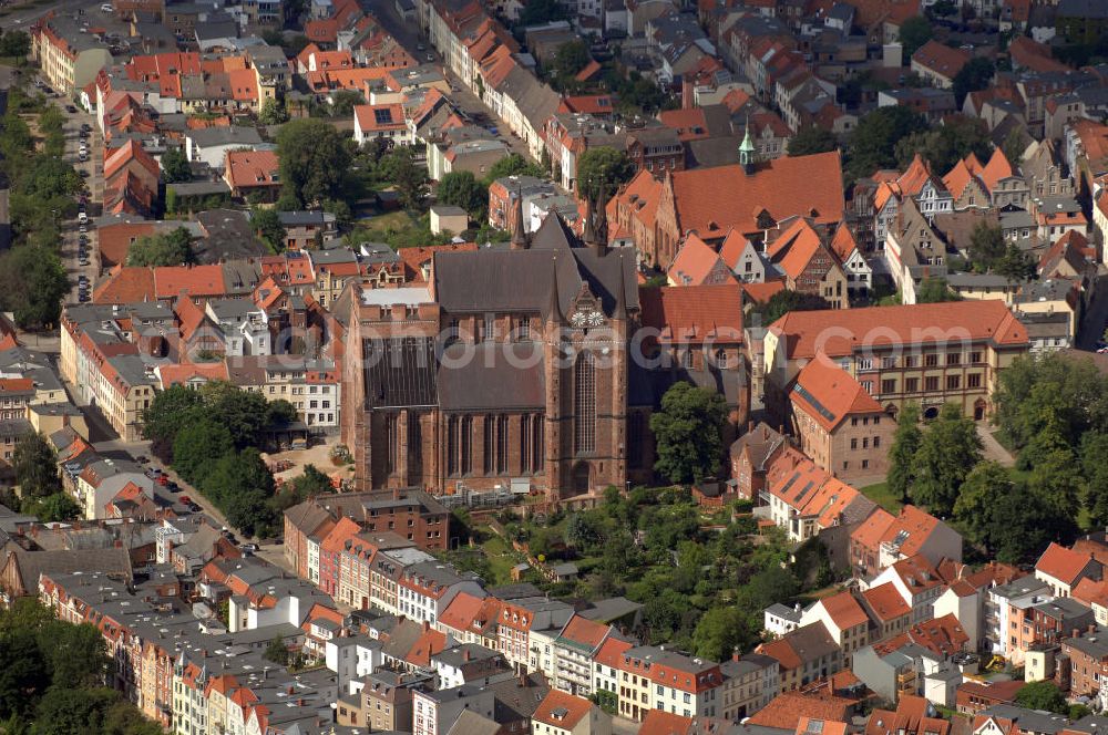 Wismar from above - Blick auf die Georgenkirche. Die Kirche St. Georgen gehört neben St. Marien und St. Nikolai zu den drei monumentalen gotischen Sakralbauten der Wismarer Altstadt. Ausgehend von der Baumasse und dem umbauten Raum ist die um 1295 begonnene Georgenkirche das größte dieser Bauwerke. Zugleich ist es auch das jüngste. Das im Zweiten Weltkrieg schwer beschädigte und zu DDR-Zeiten stark verkommene Gebäude wird bis 2010 vollständig restauriert. Die Georgenkirche ist als Teil der Wismarer Altstadt seit 2002 auf der Liste des UNESCO-Weltkulturerbes verzeichnet.