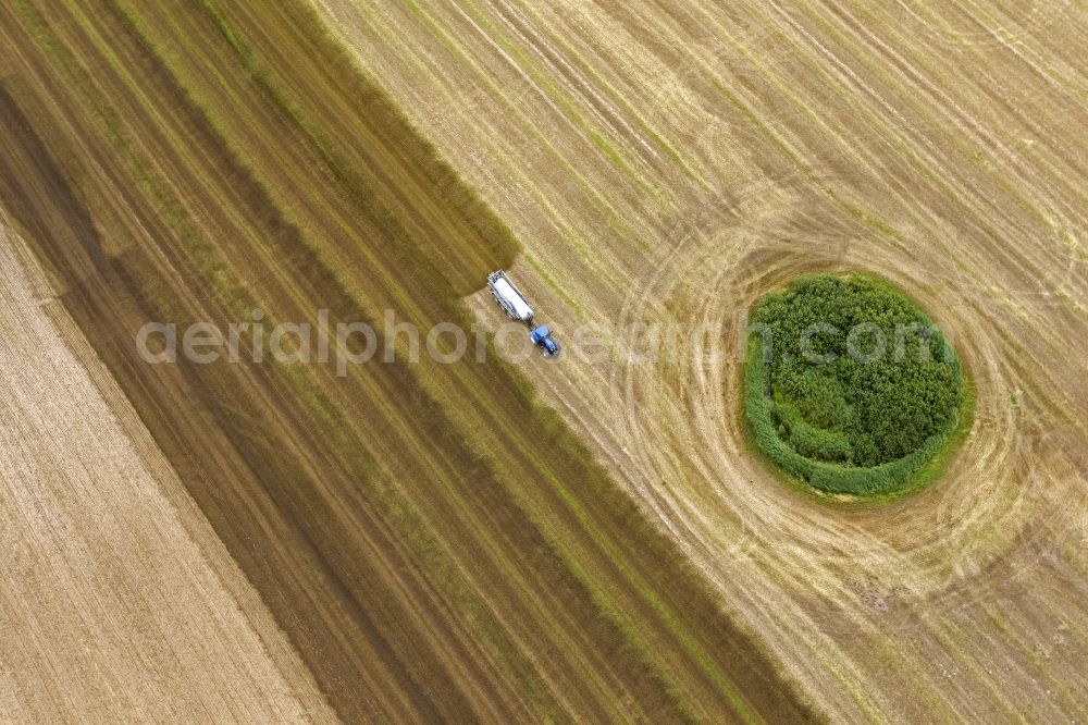 Kramerhof from above - Grain harvest in a field near Kramerhof in Mecklenburg - Western Pomerania