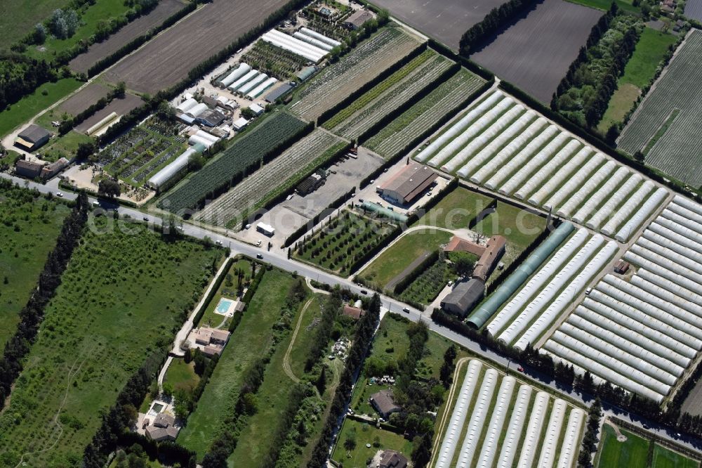 Gordes from above - Glass roof surfaces in the greenhouse for vegetable growing ranks in Gordes in Provence-Alpes-Cote d'Azur, France