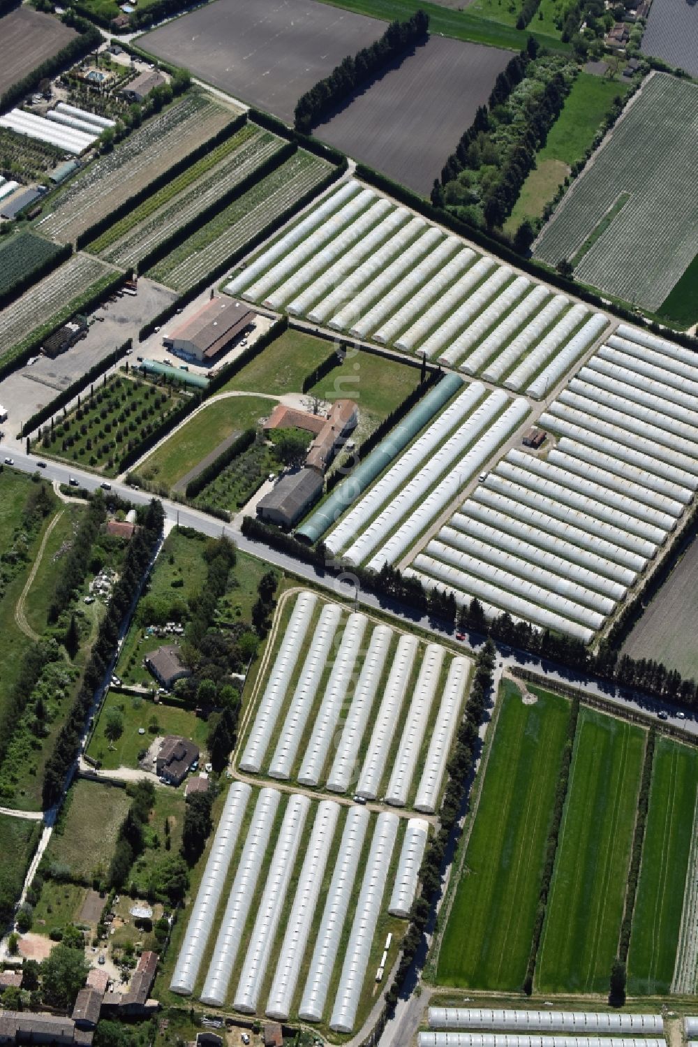 Aerial image Gordes - Glass roof surfaces in the greenhouse for vegetable growing ranks in Gordes in Provence-Alpes-Cote d'Azur, France