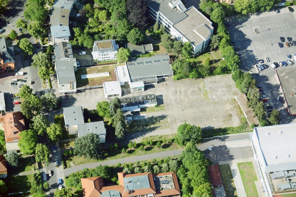 Aerial image Berlin - Gewerbebrache der ehemaligen KFZ - Pruefstelle Zehlendorf an der Charlottenstrasse in the residential area of a multi-family house settlement in Berlin in Germany. The company CDS housing Berlin GmbH is planning to build a modern residential complex