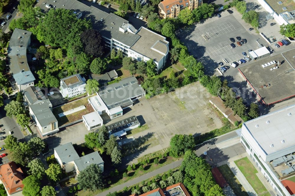 Aerial photograph Berlin - Gewerbebrache der ehemaligen KFZ - Pruefstelle Zehlendorf an der Charlottenstrasse in the residential area of a multi-family house settlement in Berlin in Germany. The company CDS housing Berlin GmbH is planning to build a modern residential complex