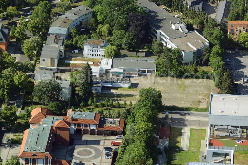 Aerial image Berlin - Gewerbebrache der ehemaligen KFZ - Pruefstelle Zehlendorf an der Charlottenstrasse in the residential area of a multi-family house settlement in Berlin in Germany. The company CDS housing Berlin GmbH is planning to build a modern residential complex