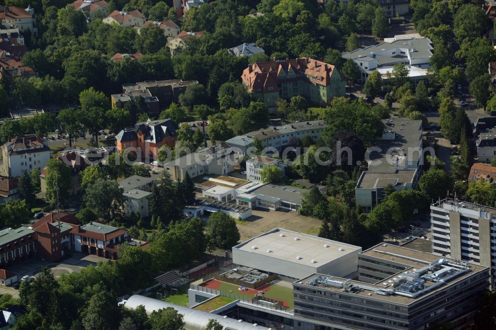 Berlin from the bird's eye view: Gewerbebrache der ehemaligen KFZ - Pruefstelle Zehlendorf an der Charlottenstrasse in the residential area of a multi-family house settlement in Berlin in Germany. The company CDS housing Berlin GmbH is planning to build a modern residential complex