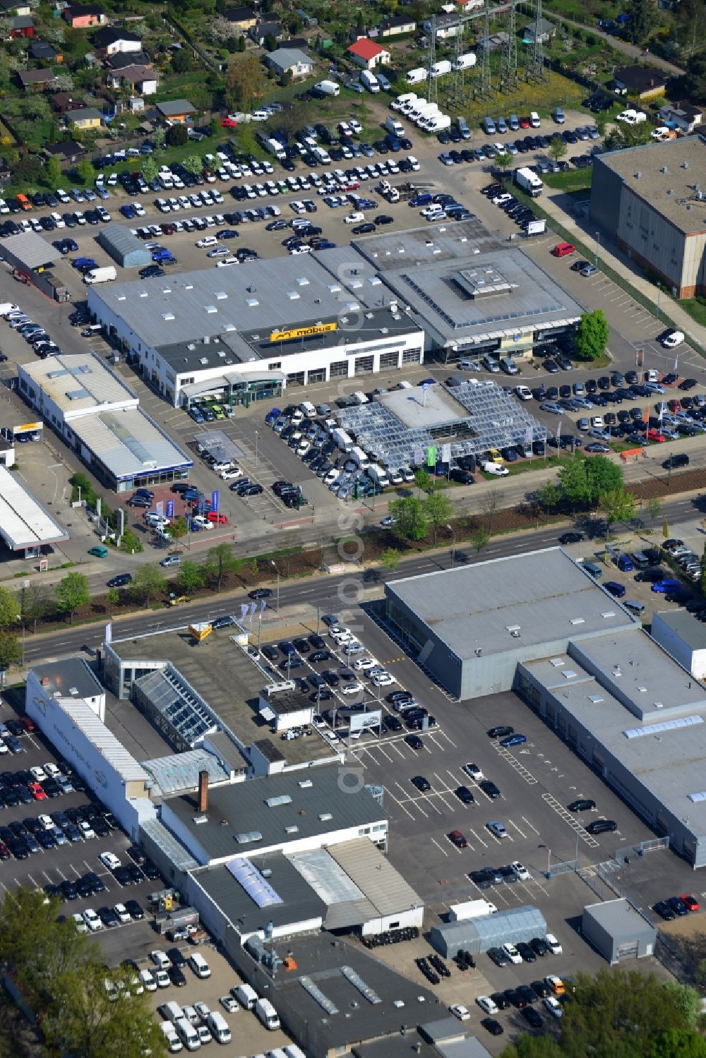 Aerial image Berlin - View at the industrial area Hansastraße in the district Weissensee in Berlin. Here are among others several car dealers, workshops and an inspection workshop of the DEKRA located