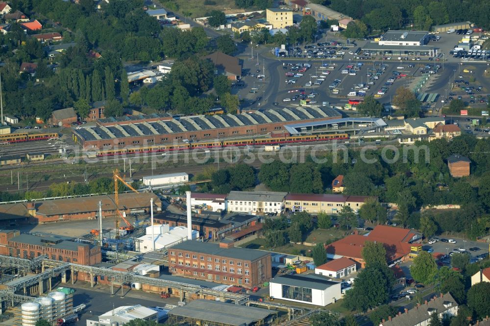 Erkner from the bird's eye view: Commercial area and train station of Erkner in the state of Brandenburg. The train station includes a hall for historic vehicles of the Berliner S-Bahn, which is part of the Friedrichsfelde works today