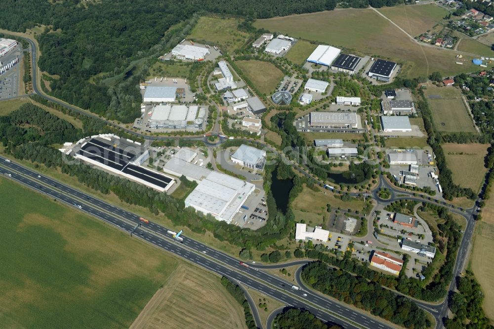 Aerial image Ludwigsfelde - Industrial estate and company settlement in at the motorway exit Genshagen in the state of Brandenburg. The area is part of the large Brandenburg Park complex