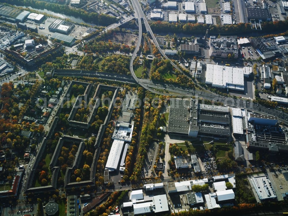 Aerial photograph Berlin - Industrial estate and company settlement between Teltow channel and federal motorway A100 in the Tempelhof part of Berlin in Germany. The area is located at the motorway exit Gradestrasse. It consists of several company compounds and halls such as Loxxess