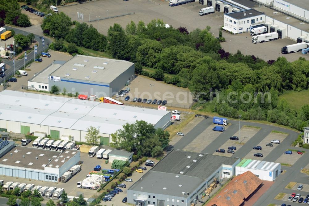 Aerial image Garbsen - Commerce area Garbsen-East in Garbsen in the state of Lower Saxony. The commercial area includes several halls, storage facilities, company buildings and parking lots. It is located adjacent to a field in the East of the town centre