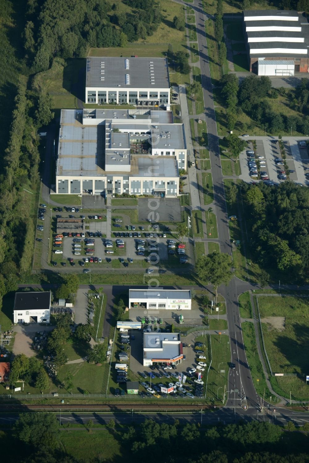 Aerial photograph Rathenow - Industrial estate and company settlement Heidefeld in the South of Rathenow in the state of Brandenburg. The compound includes a car dealership and production facilities of the glasses producer Fielmann