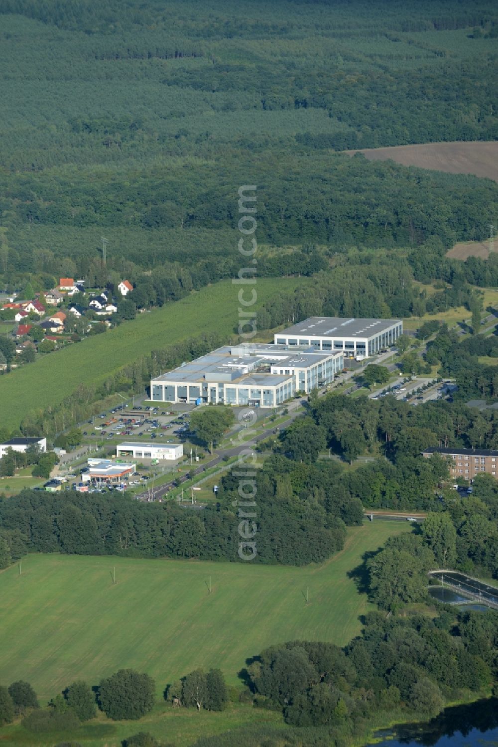 Rathenow from above - Industrial estate and company settlement Heidefeld in the South of Rathenow in the state of Brandenburg. The compound is located in the South of a residential area and the East of the river Havel. It includes a car dealership and production facilities of the glasses producer Fielmann