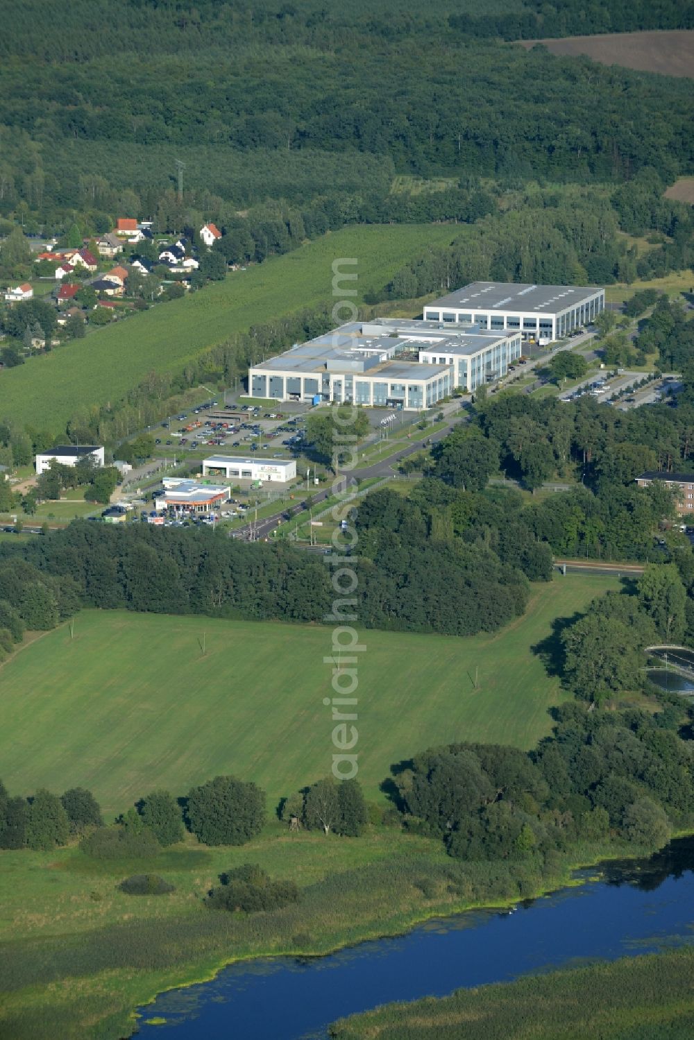 Rathenow from the bird's eye view: Industrial estate and company settlement Heidefeld in the South of Rathenow in the state of Brandenburg. The compound is located in the South of a residential area and the East of the river Havel. It includes a car dealership and production facilities of the glasses producer Fielmann