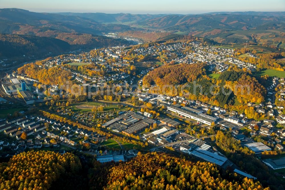 Bamenohl from the bird's eye view: Industrial estate and company settlement on Johannes Scheele Street in Bamenohl in the state of North Rhine-Westphalia. The commercial area is located in the South of the autumnal village. The background shows Finnentrop