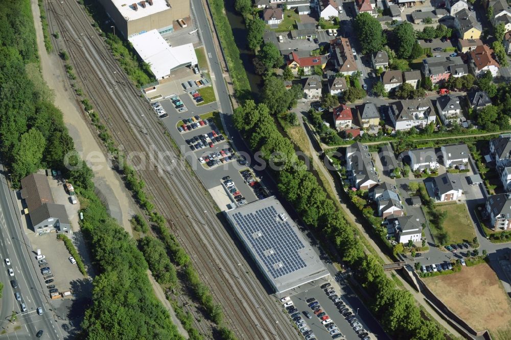 Aerial image Menden (Sauerland) - Commercial area in Menden (Sauerland) in the state of North Rhine-Westphalia. The area with supermarkets and grocery stores is located between railway tracks and the river Hoenne in the West of the town centre. It includes branches of Aldi and Edeka with solar cells on the roofs of the markets