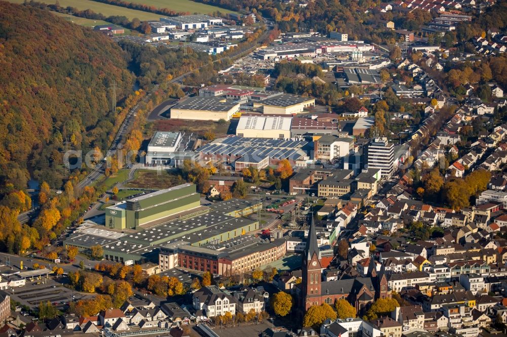 Neheim from the bird's eye view: Industrial estate and company settlement on Moehnestrasse in the North of in Neheim in the state of North Rhine-Westphalia. The commercial area is located on the edge of an autumnal forest