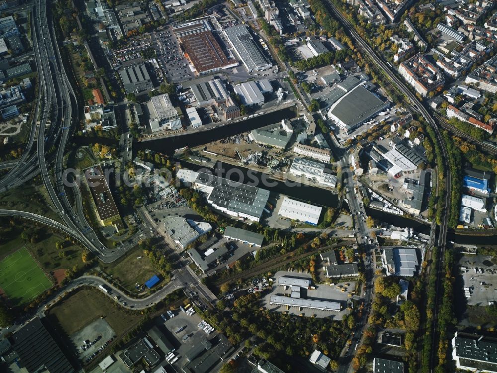 Aerial image Berlin - Industrial estate and company settlement between ring rail line, Grenzallee and federal motorway A100 in the Neukoelln district in Berlin in Germany. It is located around the Lower and Upper Harbours of Neukoelln