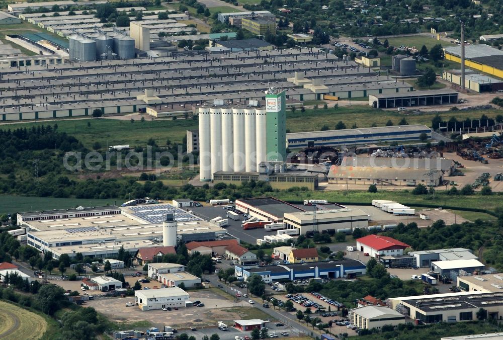 Nordhausen from above - A large commercial area of the city of Nordhausen in Thuringia is located between the South Street, Industrieweg and the road An der Helme. Here are several companies its establishment such as Kurth-Drilling GmbH, Hansa-flex AG and Nordhaeuser commodity trading GmbH. The large silo belongs to rwz Raifeisen agricultural trade