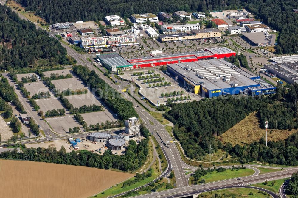 Taufkirchen from above - Commercial site Taufkirchen near Munich in the state Bayern. In the image building of the companies Ikea, Hagebaumarkt, Metro. In the foreground construction works at the Jochen Schweizer Arena