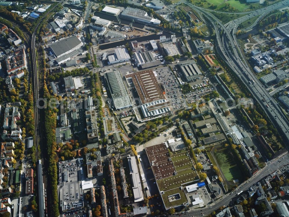 Berlin from the bird's eye view: Industrial estate and company settlement between ring rail line and Grenzalle in the South of the Neukoelln district in Berlin in Germany. The area includes a large OBI hardware store. It is located West of Upper Harbour Neukoelln and North of federal motorway A100